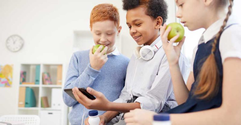 School Children Using Phone At School